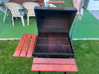 Barbacoa de carbón con mesas laterales