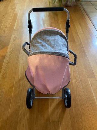 Carrito de bebé de juguete rosa y gris con bebé