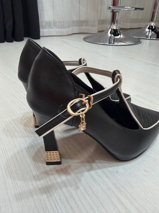 Zapatos de tacón negros con detalles dorados