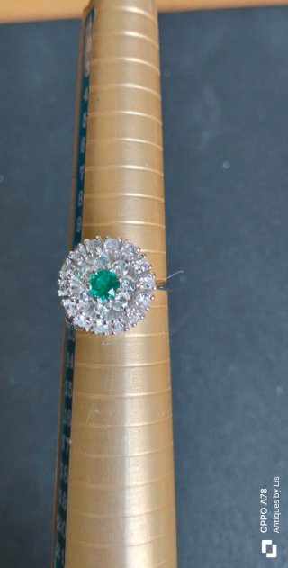 Anillo con piedra verde y detalles plateados