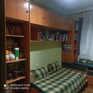 Dormitorio juvenil con estanterías y escritorio