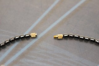 Collar de hematita y  ojo de tigre con elefante.
