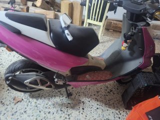 Scooter Aprilia rosa y blanco