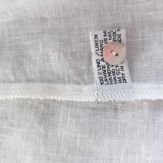 Vestitino in lino bianco con cartellino