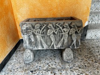 Jardinera de piedra con figuras