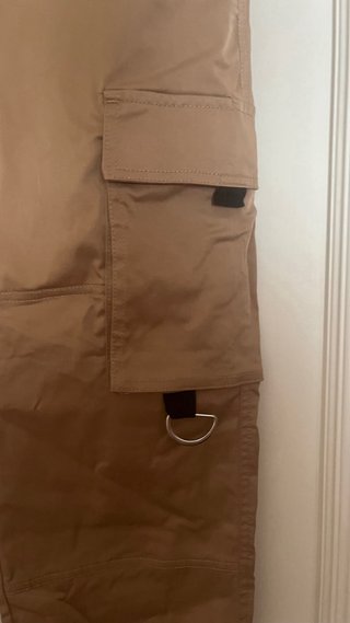 Pantalón beige con cinturón negro