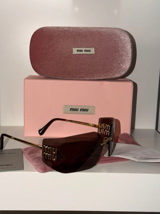 Gafas de sol Miu Miu marrones y doradas