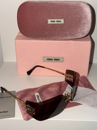 Gafas de sol Miu Miu marrones y doradas
