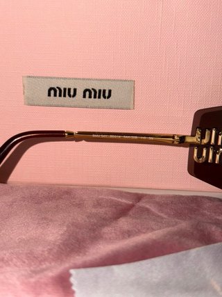 Gafas de sol Miu Miu marrones y doradas