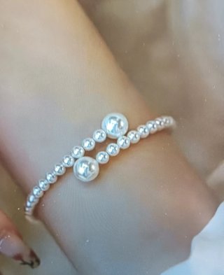 Bracciale perle sintetiche regolabile. Nuovo.