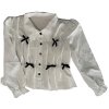 Camisa blanca con lazos negros