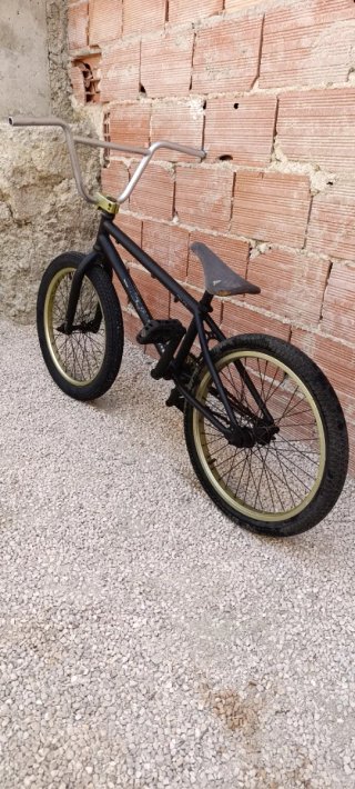 Bicicleta BMX negra con ruedas doradas