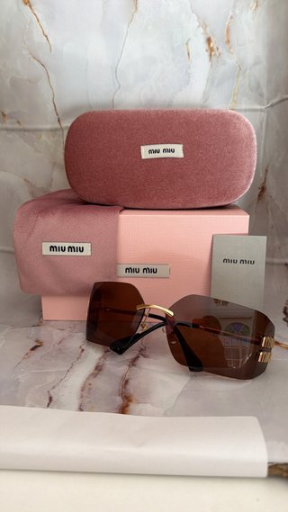 Gafas de sol Miu Miu marrones y doradas