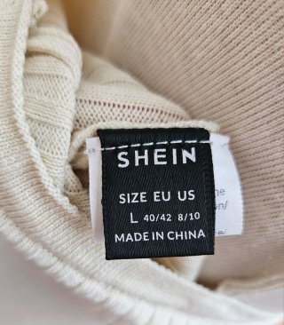 Top de punto beige sin mangas