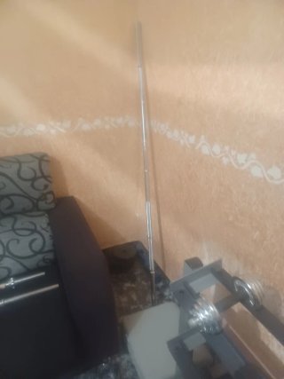 Banco de gimnasio con barras y pesas