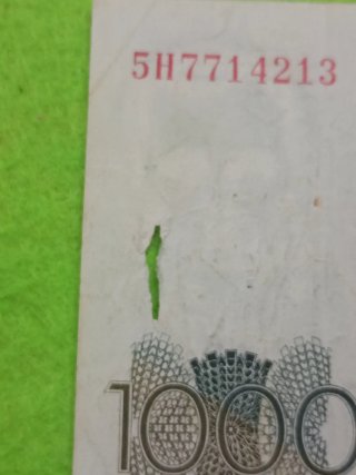 Billete usado con algún desperfecto del uso 1000