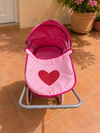 Cochecito de muñecas rosa carrito