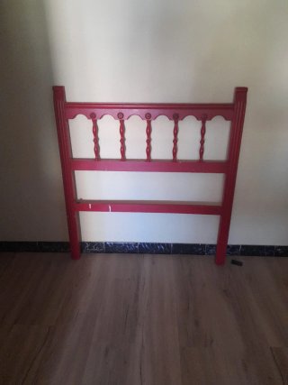 Cabecero de cama de madera pintado en rojo.
