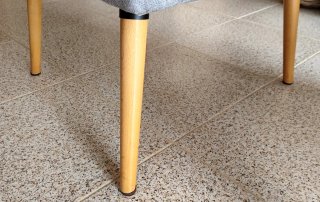 Butaca gris de tela con patas de madera