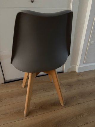 2 Sillas de comedor grises con patas de madera.