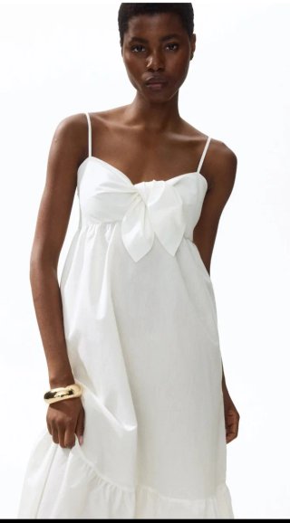 Vestido crema HM escalonado con nudo decorativo