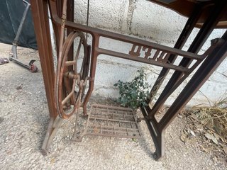 Mesa antigua de madera con máquina de coser