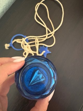 Peonza azul con cuerda y estrella