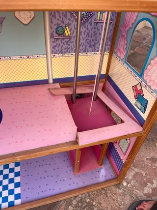 Casa de muñecas de madera con ascensor.