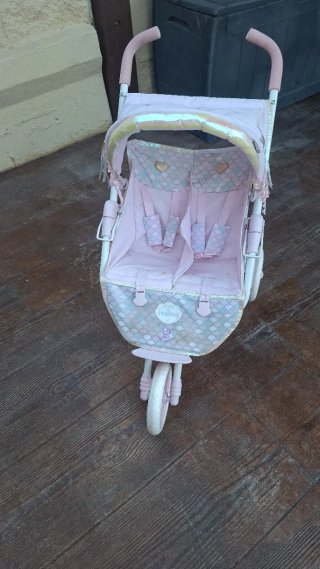 Carro gemelar de juguete rosa