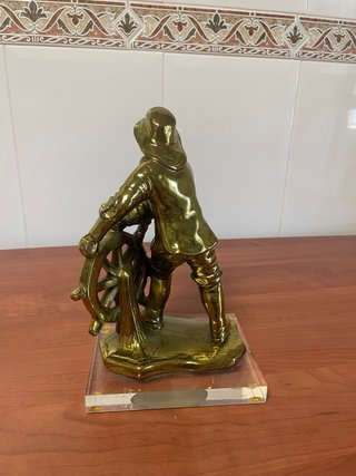 Figura marinero timón metal dorado base mármol.