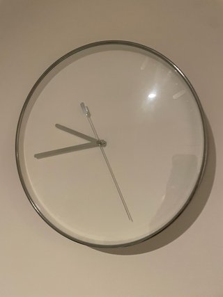 Reloj de pared plateado y blanco