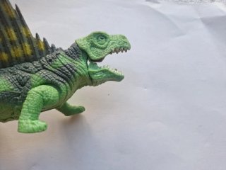 Dinosaurio de juguete con vela