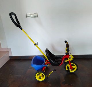 Triciclo Puky rojo y amarillo con remolque