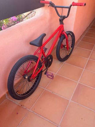 Bicicleta Roja Con signos de desgaste y freno roto