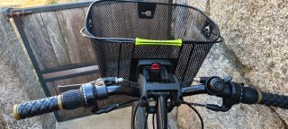 Bicicleta de paseo negra con cesta extraíble.