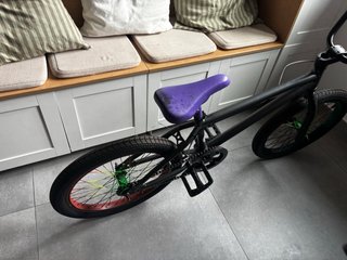 Bicicleta BMX negra con ruedas de colores