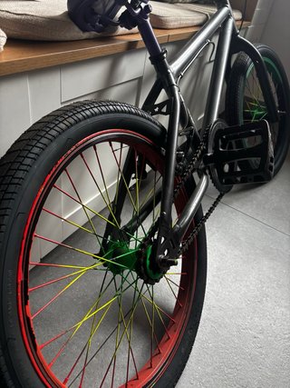 Bicicleta BMX negra con ruedas de colores