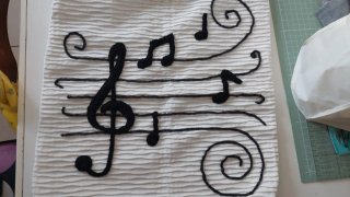 Copricuscino con note musicali nere