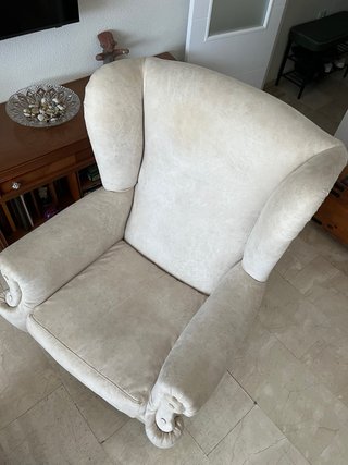 Sillón orejero clásico beige con reposapiés