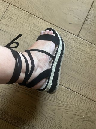 Sandalias cuña negras atadas a pierna