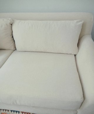 Sofá de tela beige. Armazón de madera de pino