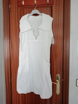 Vestido blanco sin mangas con cremallera.
