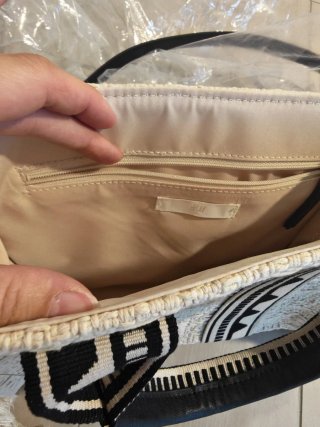 Bolso de tela beige y negro con flecos