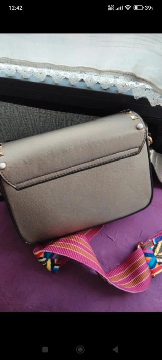 Bolso joya dorado con tachuelas y piedras