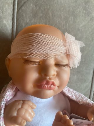 Muñeca bebé con música y luz