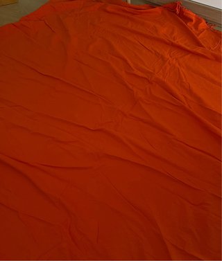 Colcha redonda naranja con flecos