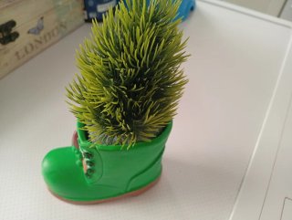 Figura cerámica verde  con forma de bota, con pino