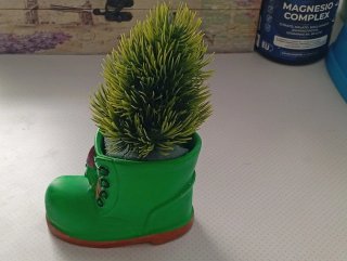 Figura cerámica verde  con forma de bota, con pino