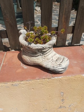 Jardinera de piedra con forma de bota