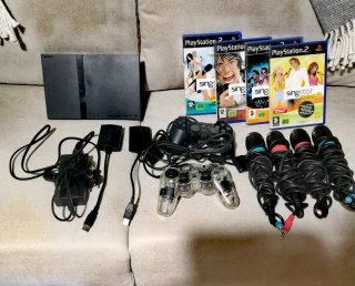 Consola PS2 con juegos Singstar y accesorios
